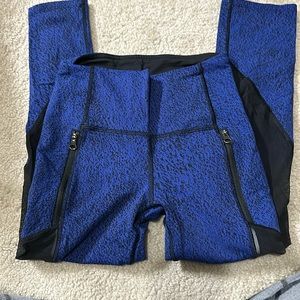 Lululemon blue cropped leggings with mesh detail and pockets.